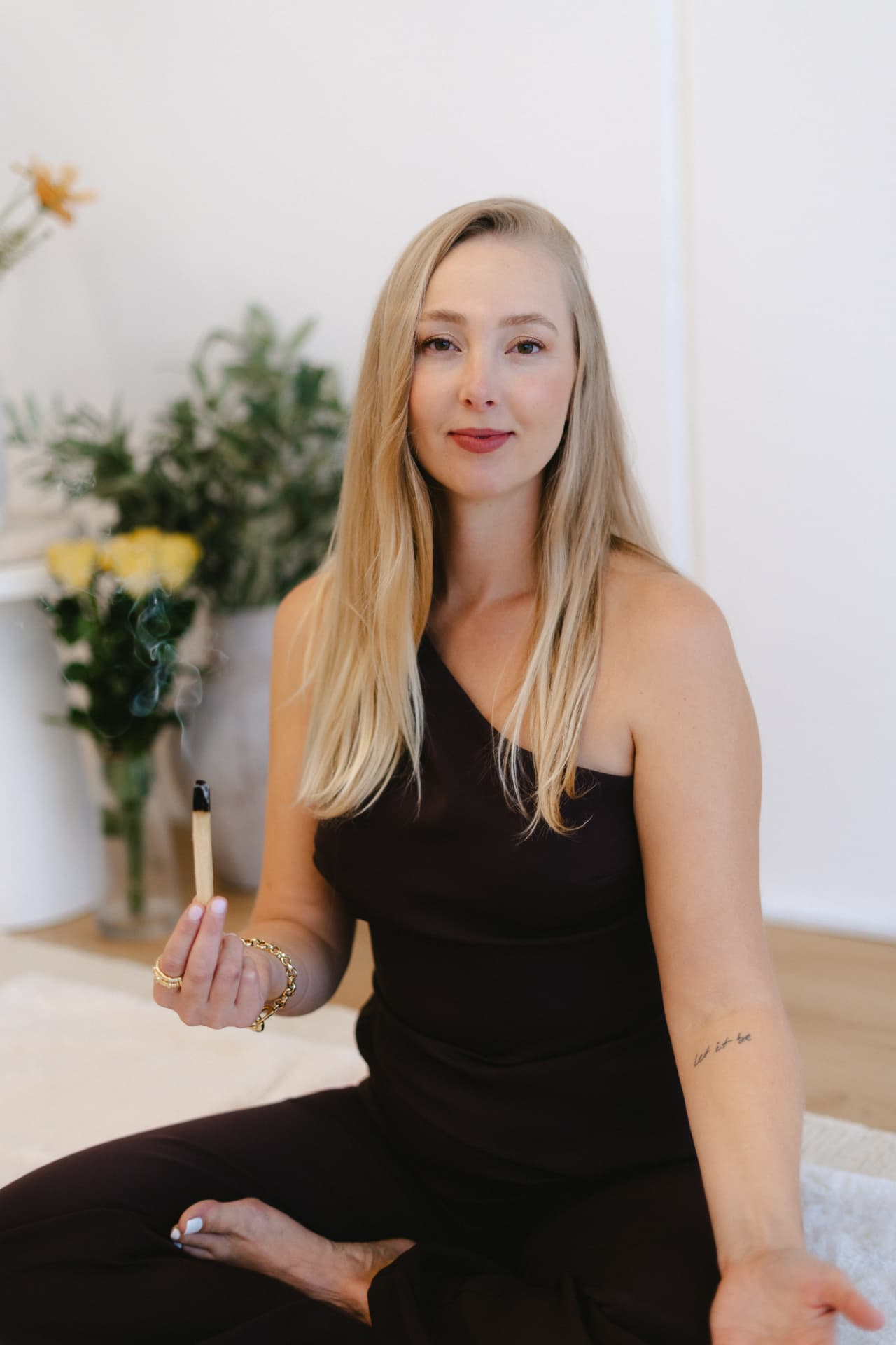 Andressa Peters holding a palo santo stick