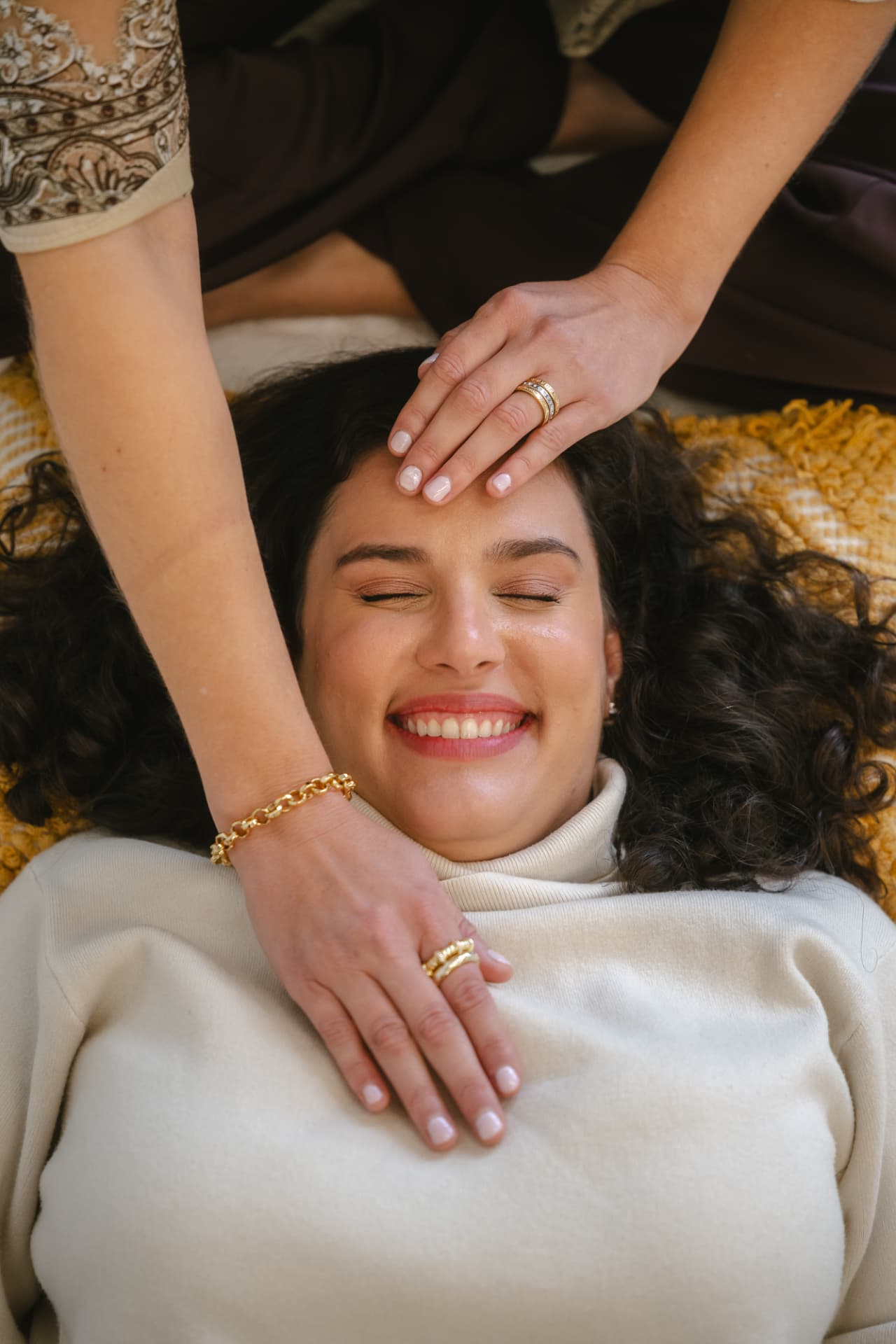 Reiki hands resting gently on a smiling client